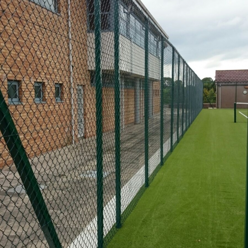 A large fence erected at a tennis court in Ballymena. View from inside the tennis court.
